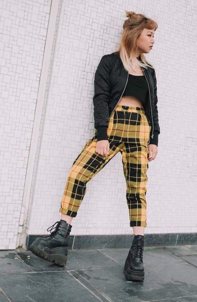 Yellow Plaid Trousers with Black Crop Top along with a Bomber Jacket